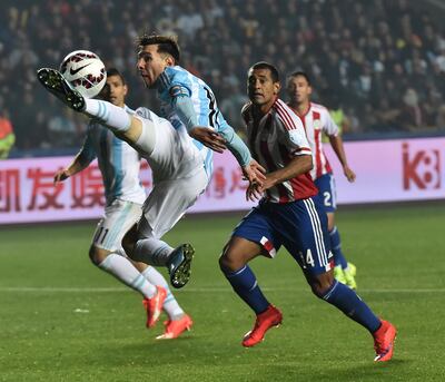 Argentina's forward Lionel Messi (L) jumps for the ball beside Paraguay's defender Paulo Da Silva during their Copa America semifinal football match in Concepcion, Chile on June 30, 2015.   AFP PHOTO / NELSON ALMEIDA (Photo by NELSON ALMEIDA / AFP)