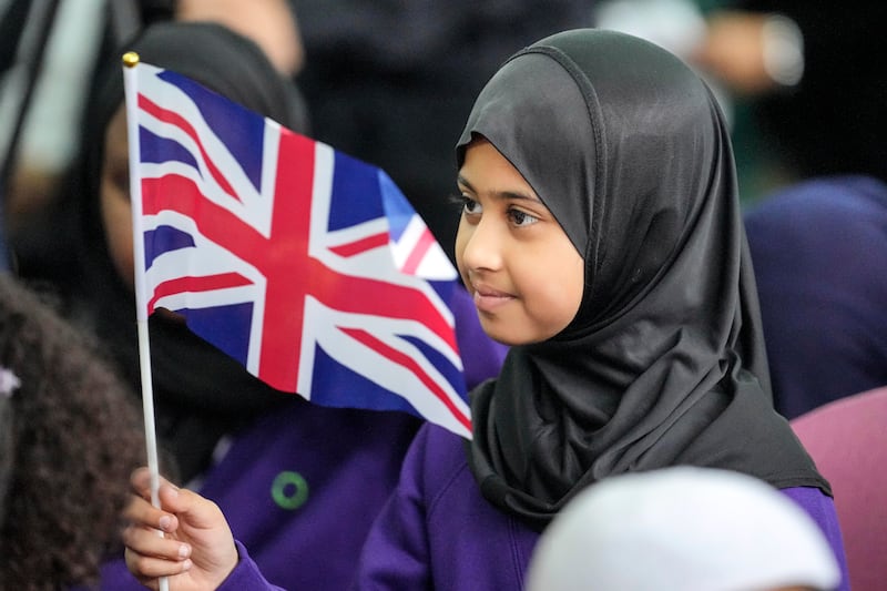 A young girl at a national Muslim memorial for the late Queen Elizabeth II at the London Central Mosque. AP