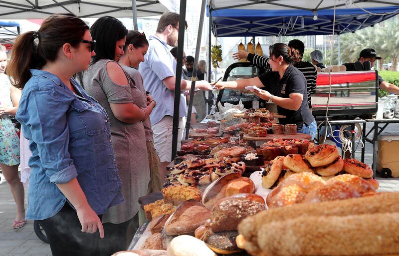 DUBAI , UNITED ARAB EMIRATES , January 18 – 2019 :- People buying different types of organic breads at one of the shop at the Farmers Market held at the Bay Avenue in Business Bay in Dubai. (Pawan Singh / The National ) For News/Online/Instagram. Story by Patrick