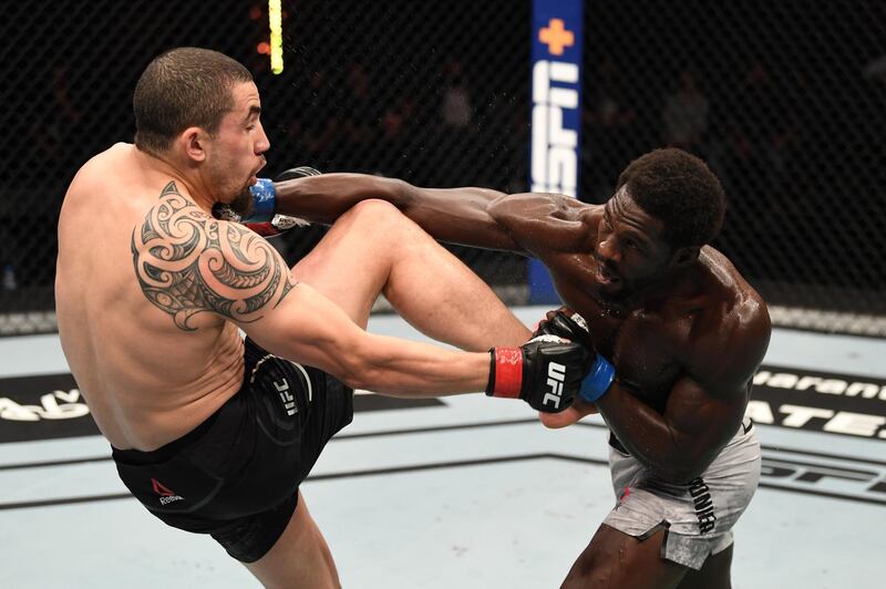 Jared Cannonier punches Robert Whittaker. Getty