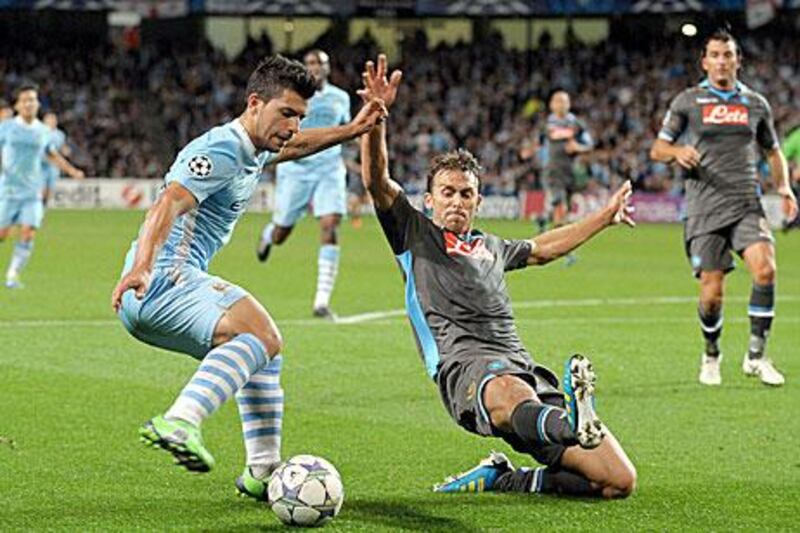 Manchester City's Sergio Aguero, left, attempts to take the ball past Napoli's Salvatore Aronica.