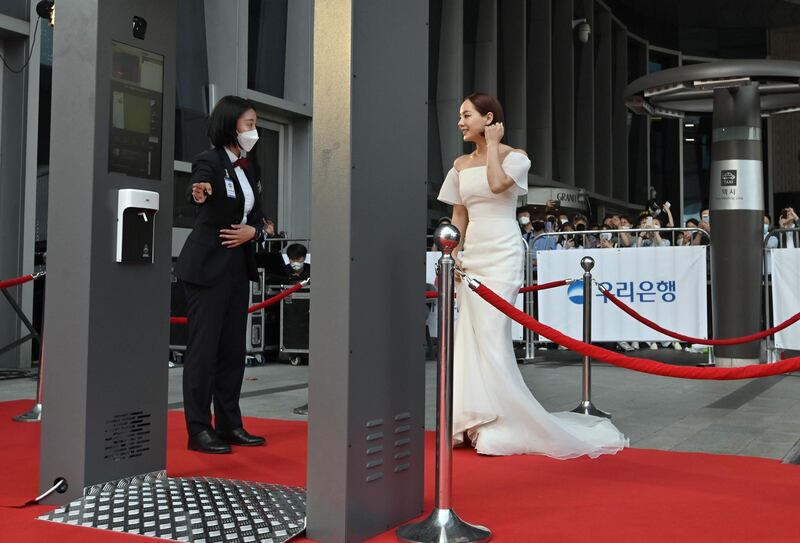 Actress Eugene walks through a thermal camera system as she arrives on the red carpet of the 56th annual Daejong Film Awards in Seoul. AFP