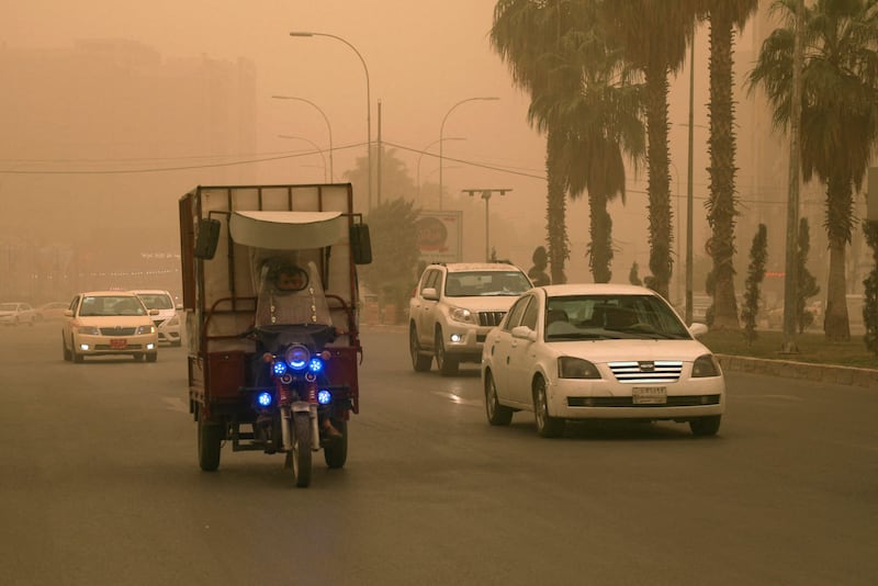 A tuk-tuk driver makes his way through the haze in a sandstorm in Arbil, the capital of the Kurdish autonomous region in northern Iraq.