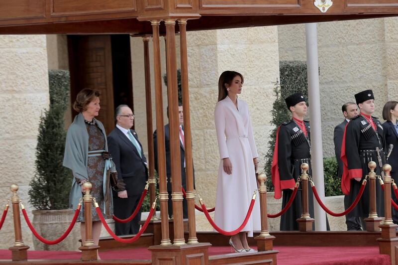 Jordan's Queen Rania, centre, walks with Norway's Queen Sonja, left, on the reviewing stand. AP Photo