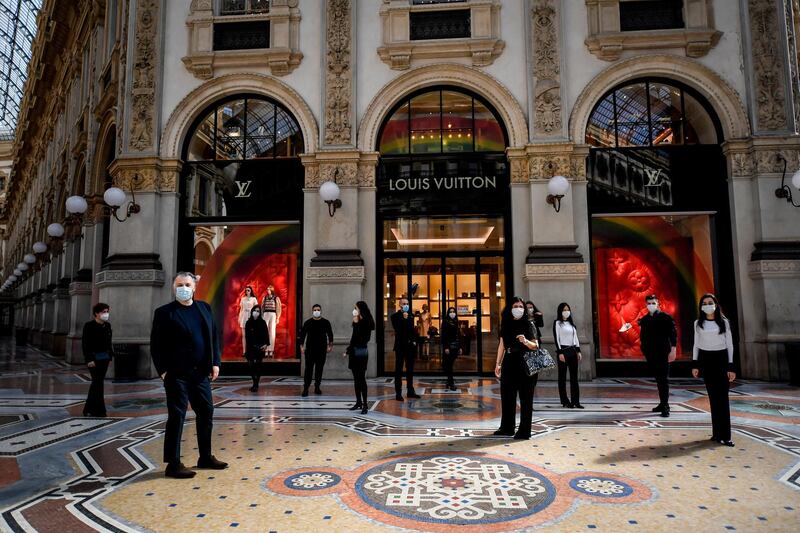 Market vendors protest rules that do not allow them to restart their activity, at the Galleria Vittorio Emanuele II shopping arcade in Milan, Italy.  AP