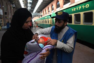 A health worker administers polio drops to a child at a railway station during a polio vaccination campaign in Lahore on November 5, 2019. Arif Ali / AFP 
