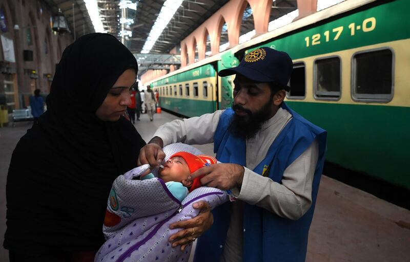 A Pakistani health worker administers polio drops to a child at a railway station during a polio vaccination campaign in Lahore on November 5, 2019. 







  / AFP / Arif ALI
