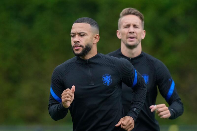 Memphis Depay, left, and Luuk de Jong warm up during training before the Euro 2020 match against North Macedonia. AP