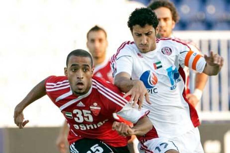 Al Ahli’s Abdulla Abdulrahman, left, and Ali Saleh Abdulla, of Al Jazira, chase after the ball during first-half action.