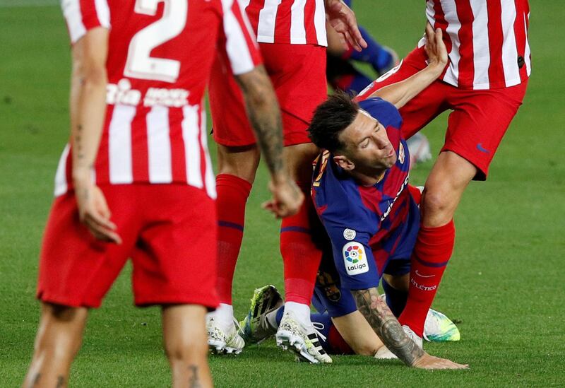 Messi in action with Atletico's Saul Niguez and Felipe. Reuters