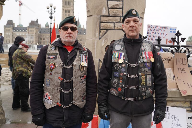 Two men pose outside of Parliament. Willy Lowry / The National