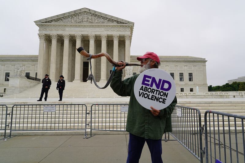 A pro-life supporter stands in front of the Supreme Court. Willy Lowry / The National