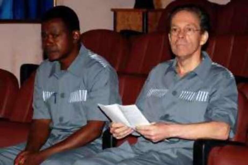 British mercenary Simon Mann (R) sits in front of a court in Malabo in this June 17, 2008 file photo.  A court in Equatorial Guinea on July 7 sentenced British mercenary Simon Mann to 34 years and four months in prison for his confessed role in a failed 2004 coup plot in the oil-producing West African state.    REUTERS/Ceiba News Magazine/Handout  (EQUATORIAL GUINEA).  FOR EDITORIAL USE ONLY. NOT FOR SALE FOR MARKETING OR ADVERTISING CAMPAIGNS. *** Local Caption ***  AFR15_EQUATORIAL-PL_0707_11.JPG