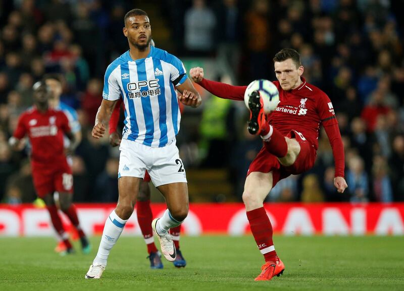 Premier League - Liverpool v Huddersfield Town - Anfield, Liverpool, Britain - April 26, 2019  Huddersfield Town's Steve Mounie in action with Liverpool's Andrew Robertson         REUTERS/Andrew Yates  EDITORIAL USE ONLY. No use with unauthorized audio, video, data, fixture lists, club/league logos or "live" services. Online in-match use limited to 75 images, no video emulation. No use in betting, games or single club/league/player publications.  Please contact your account representative for further details.