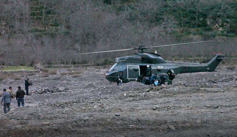 An image grab taken from a video broadcast in Morocco's news channel KECH24 on December 18, 2018 shows a helicopter at the scene of a crime where the bodies of two Scandinavian women were found the day before in an isolated mountainous area 10 kilometres (six miles) from the tourist village of Imlil in the High Atlas range. Moroccan authorities on December 18, 2018 arrested a suspect following the murder of a Danish and Norwegian hiker, who were found dead with cuts to their necks, the interior ministry said. Imlil is a starting point for trekking and climbing tours of Mount Toubkal, which at 4,167 metres is the highest summit in North Africa. / AFP / KECH24 Moroccan News Channel / -
