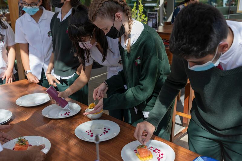 Students plate up a fine-dining dish.
