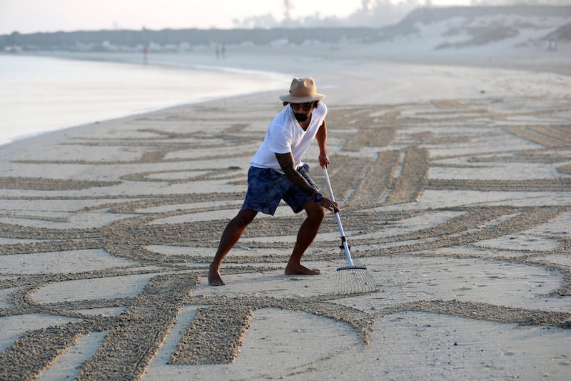 Dubai, United Arab Emirates - Reporter: N/A. Features. Sand artist Nathaniel Alapide draws murals on the beach using a rake in Jebel Ali. Tuesday, November 3rd, 2020. Dubai. Chris Whiteoak / The National

Please don't use for a standalone planned feature for early December