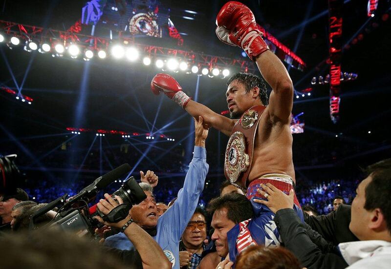 Pacquiao's career record improved to 55 wins, five losses and two draws on Sunday. Vincent Yu / AP