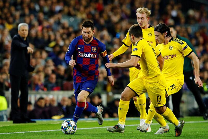 Borussia Dortmund players attempt to stop Barcelona attacker Lionel Messi. EPA
