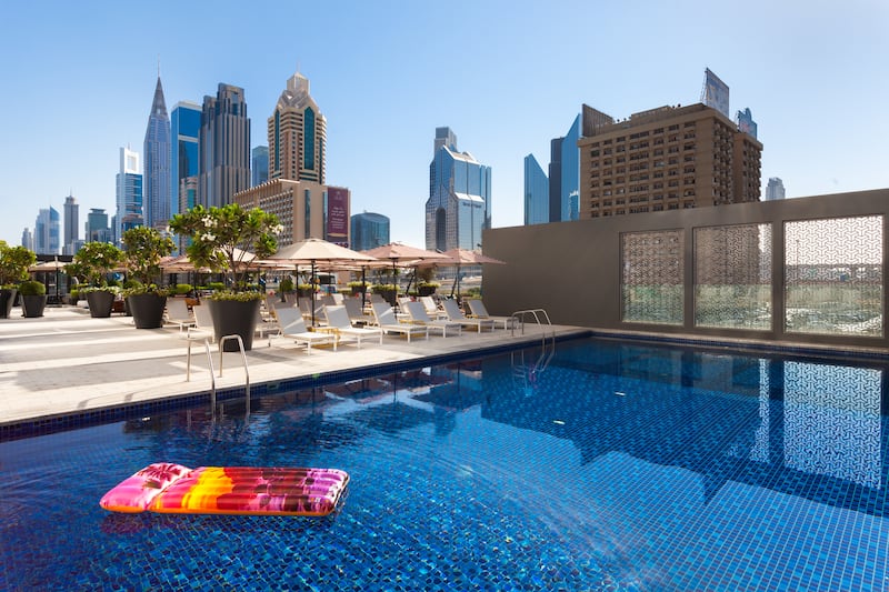 The outdoor pool comes with city skyline views.