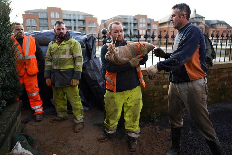 Employees of York City Council use sand bags to increase flood defences as the River Ouse in York continues to rise potentially causing further flooding as Storm Dennis causes disruption across the country in York, United Kingdom. Getty Images