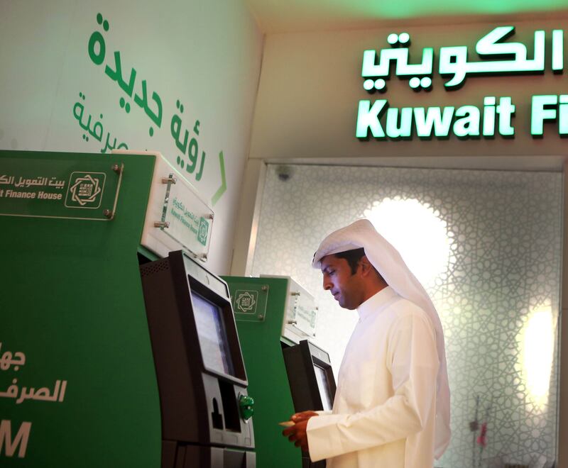 TO GO WITH AFP ECO STORY BY OMAR HASAN
A Kuwaiti man withdraws cash from an ATM outside a Kuwait Finance House branch inside the Avenues Mall, the largest shopping centre in Kuwait on November 19, 2014. The International Monetary Fund (IMF), the World Bank, and other global economic bodies estimate that the assets of Islamic financial institutions grew nine-fold to USD 1.8 trillion between 2003 and last year.  AFP PHOTO/ YASSER AL-ZAYYAT / AFP PHOTO / YASSER AL-ZAYYAT