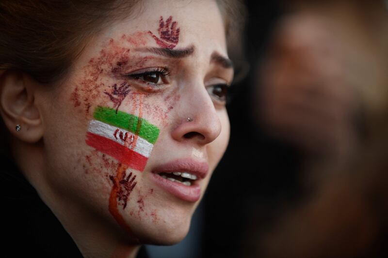 A woman shows her true colours in the protest against the Iranian government, in Paris. AFP