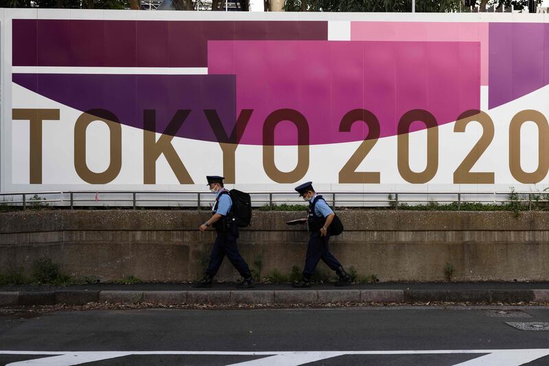 Police officers pass a fence outside a venue for archery at the upcoming Tokyo 2020 Olympic Games, in Tokyo on July 21. AFP