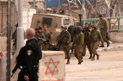 Israeli security forces cordon off the site of a reported attack at the Beit Einun junction, east of the West Bank city of Hebron on April 21, 2024. AFP