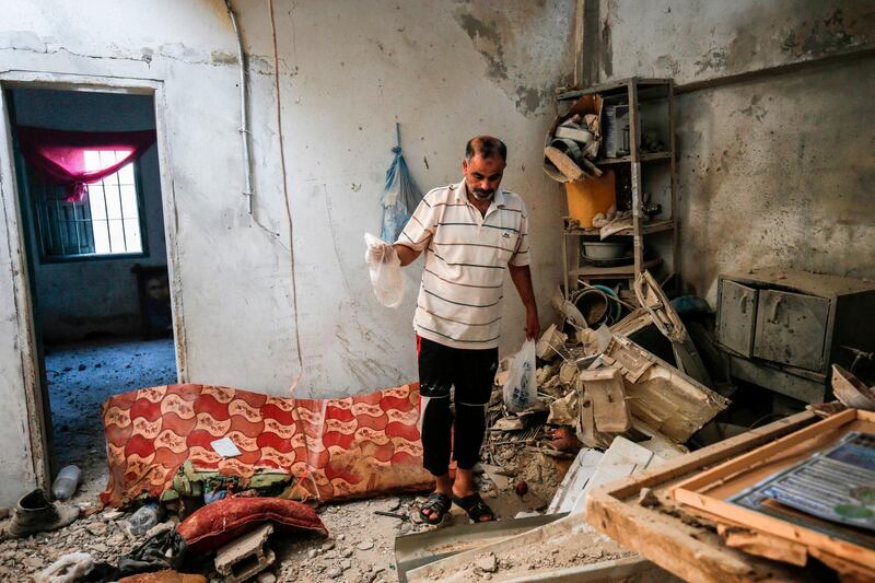 A relative of 23-year-old Palestinian Enas Khammash, who was killed with her toddler in an Israeli airstrike, inspects their damaged home in Deir Al-Balah in Gaza Strip. AFP