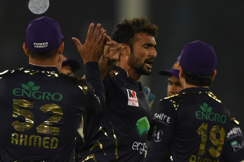 Quetta Gladiators' Sohail Khan, centre, celebrates with team mates after taking the wicket of Islamabad United's Luke Ronchi. AFP