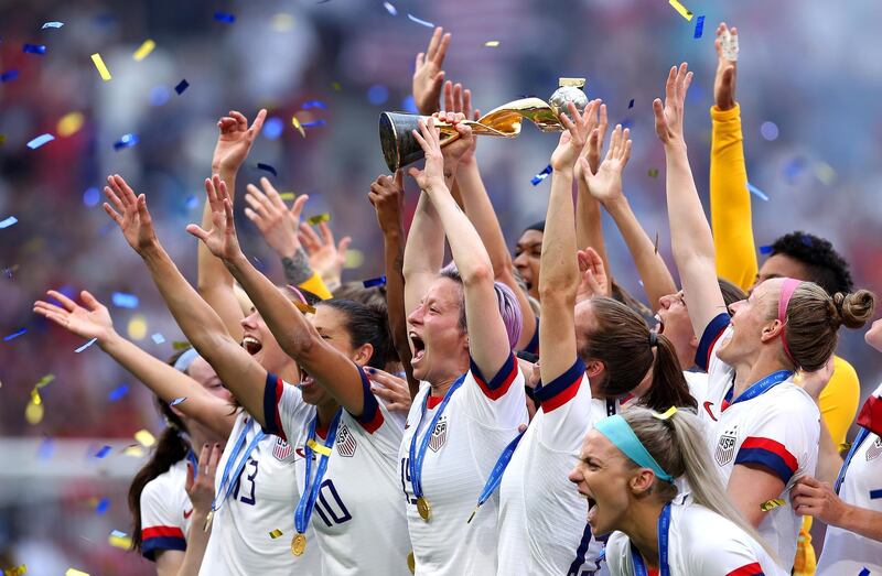 LYON, FRANCE - JULY 07:  Megan Rapinoe of the USA lifts the FIFA Women's World Cup Trophy following her team's victory in the 2019 FIFA Women's World Cup France Final match between The United States of America and The Netherlands at Stade de Lyon on July 07, 2019 in Lyon, France. (Photo by Alex Grimm/Getty Images) *** BESTPIX ***
