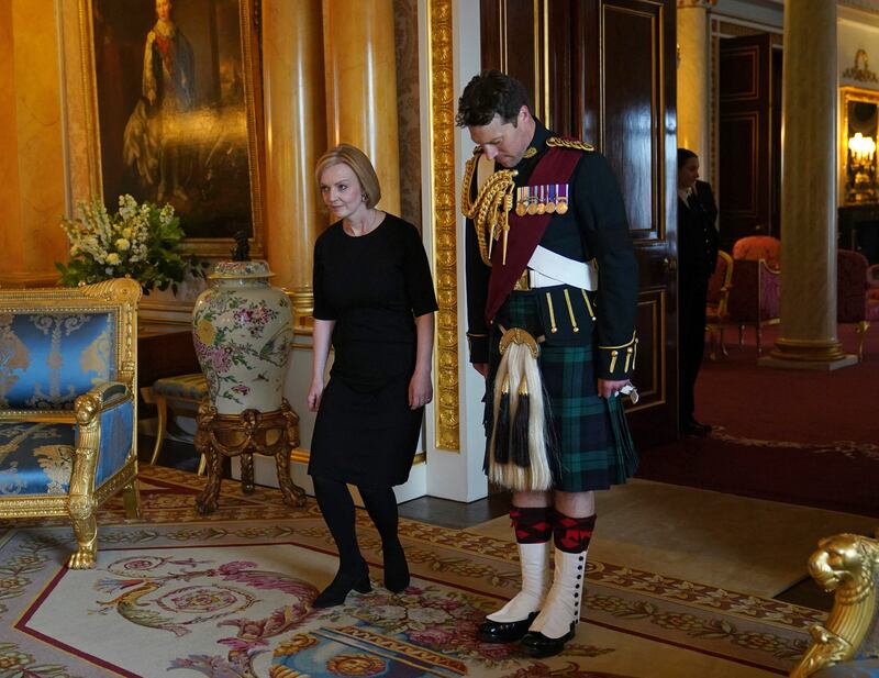 Then UK prime minister Liz Truss curtsies as she arrives to meet King Charles III, at Buckingham Palace in London on September 9, 2022. AFP