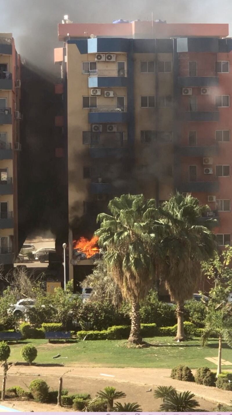 Smoke and fire rise from an apartment building, after a shell hit the complex in Khartoum. Reuters