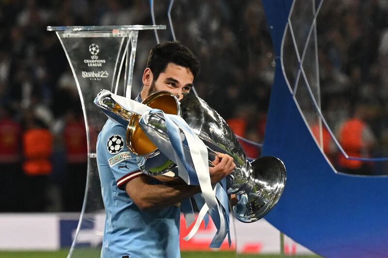 Manchester City's German midfielder #8 Ilkay Gundogan poses with the European Cup trophy as they celebrate winning the UEFA Champions League final football match between Inter Milan and Manchester City at the Ataturk Olympic Stadium in Istanbul. AFP
