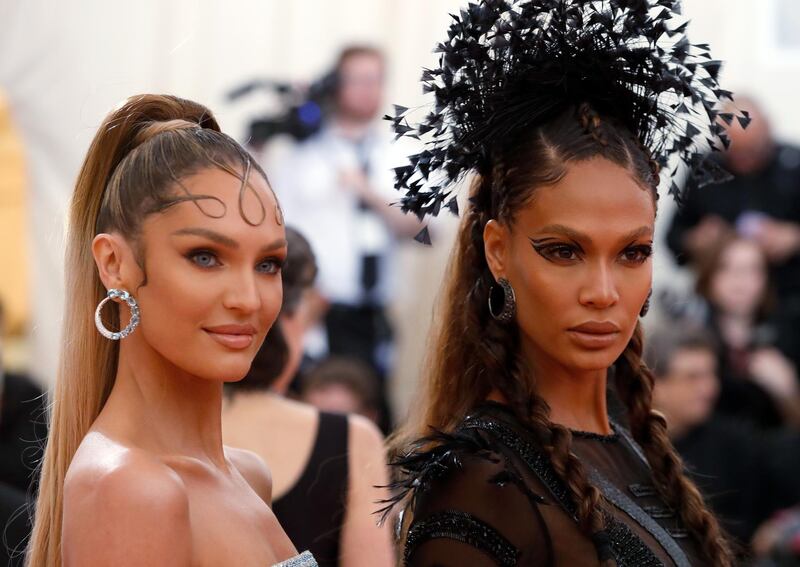 Model Candice Swanepoel sported an intricate curled fringe, created using gelled strands of hair, while her fellow catwalk star Joan Smalls showed how negative eyeliner should be done. Reuters