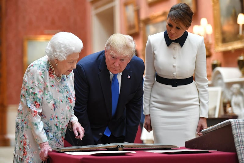 Britain's Queen Elizabeth II (L) views a display of US items of the Royal collection with US President Donald Trump and US First Lady Melania Trump at Buckingham Palace. AFP