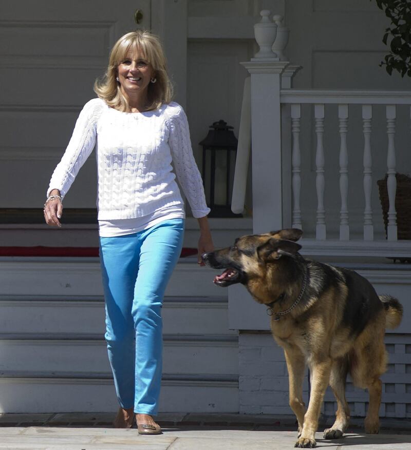 First lady Jill Biden with the family's dog, Champ, arrives to help assemble Mother's Day packages that deployed US troops have requested to be sent to their mothers and wives at home as part of a Joining Forces service event at the Naval Observatory in Washington, DC, May 10, 2012. AFP