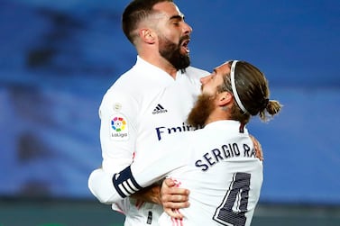 Real Madrid's Dani Carvajal celebrates with Sergio Ramos after Atletico Madrid's Jan Oblak scored an own goal. Reuters