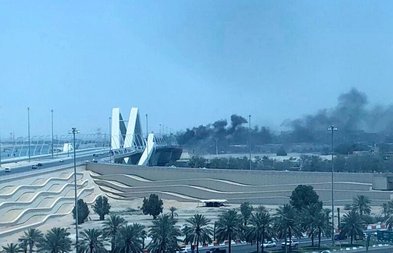 Smoke billows from Sheikh Zayed Bridge after a car catches fire. The National