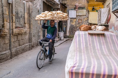 A bakery worker delivering fresh bread in Cairo. Bloomberg