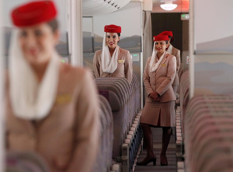 Emirates cabin crew stand on board an Emirates Airbus A380-800 after it landed at Manchester Airport in Manchester, northern England, September 1, 2010. Manchester Airport became the world's first regional airport to have a regular A380 service, according to an airport press release.     REUTERS/Phil Noble (BRITAIN - Tags: TRANSPORT BUSINESS TRAVEL) - RTR2HSIH