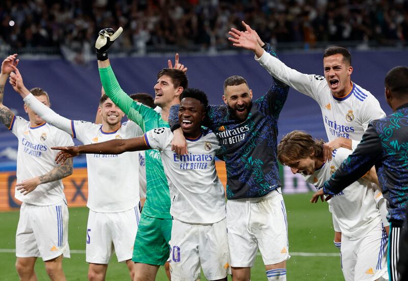 Real Madrid's Karim Benzema, Thibaut Courtois, Vinicius Junior, Luka Modric and teammates celebrate reaching the Champions League final. Reuters