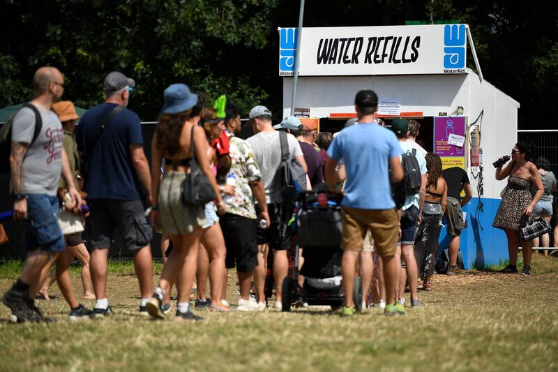 GLASTONBURY, ENGLAND - JUNE 29: Festival-goers queue at a water refill point during day four of Glastonbury Festival at Worthy Farm, Pilton on June 29, 2019 in Glastonbury, England. Glastonbury is the largest greenfield festival in the world, and is attended by around 175,000 people. (Photo by Leon Neal/Getty Images)