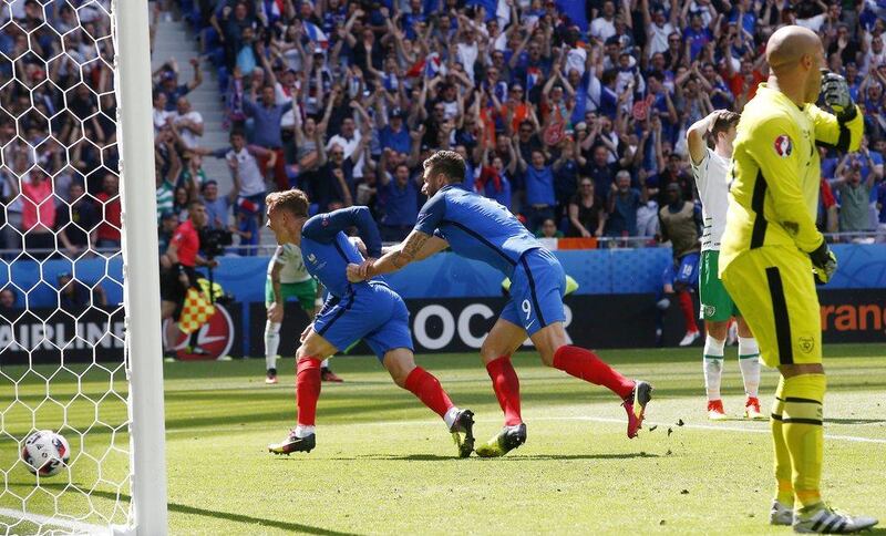 Antoine Griezmann celebrates with teammate Olivier Giroud after scoring France’s second goal. Thibault Camus / AP Photo