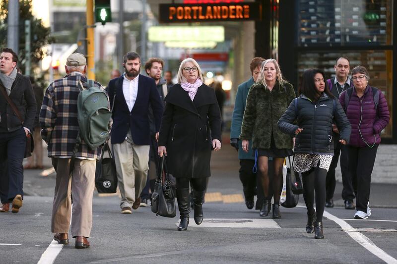 People make their way into the CBD during the first day under COVID-19 Alert Level 1 in Wellington, New Zealand. Getty Images