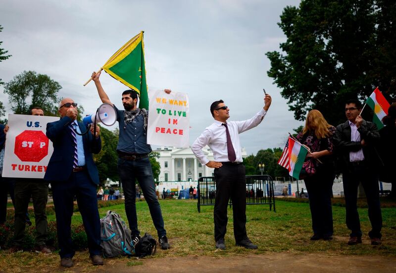 Protesters demonstrate against US President Donald Trump's decision to withdraw US troops from northeastern Syria in front of the White House in Washington.  AFP