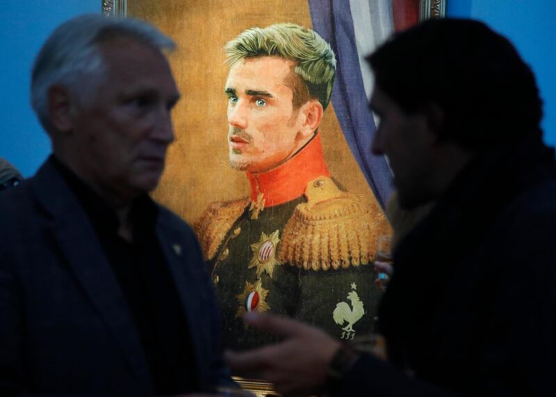 Visitors speak in front of portrait of France's Antoine Griezmann at the Museum of Academy of Arts in St.Petersburg, Russia. Dmitri Lovetsky / AP Photo