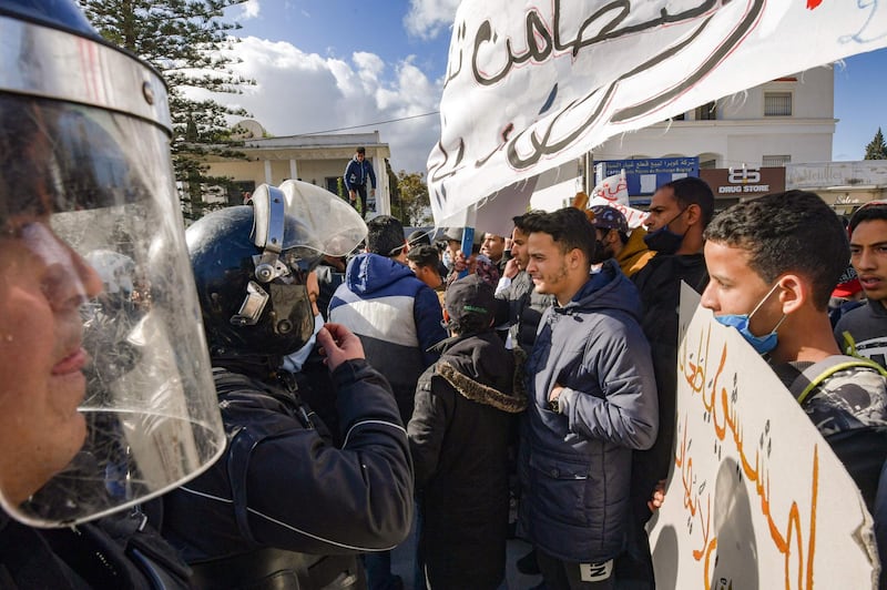 Security forces confront protesters from the Ettadhamen city suburb on the northwestwern outskirts of Tunisia's capital Tunis as they prevent them from passage onwards to reach an anti-government demonstration outside the Tunisian Assembly (parliament) headquarters. AFP