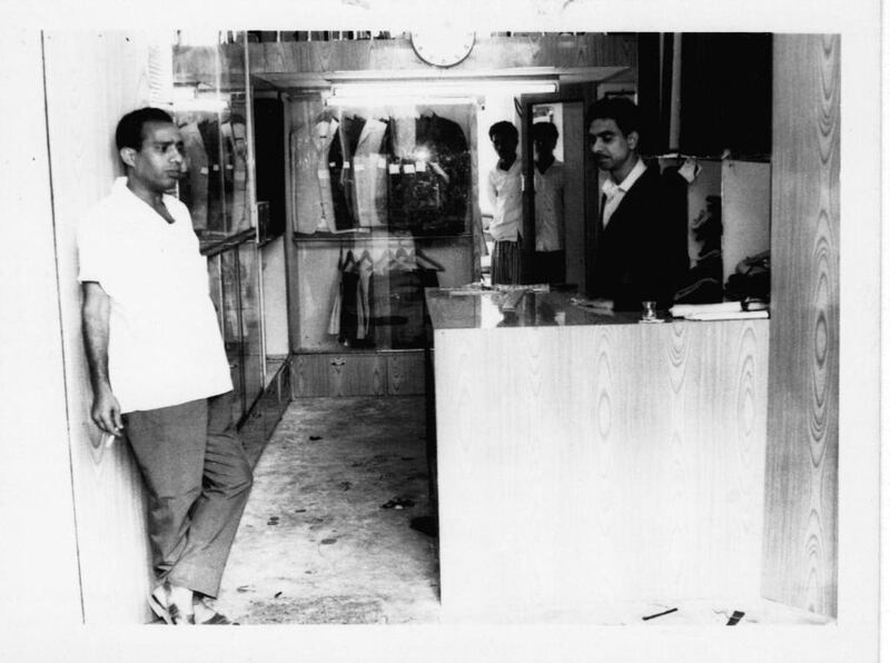 PN Parmar, right, the founder and chairman of Parmar Tailors. Taken in the 1960s, this photo shows Parmar’s first shop which he opened opposite the creek in 1962. Reem Mohammed / The National